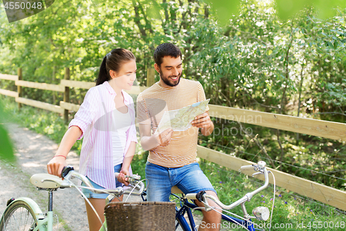 Image of couple with map and bicycles at country in summer