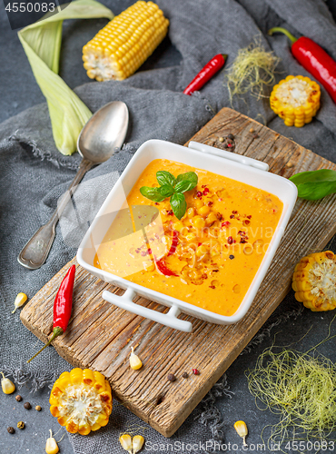 Image of Creamy corn soup with chili in a white bowl.