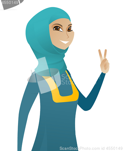 Image of Young muslim businesswoman showing victory gesture