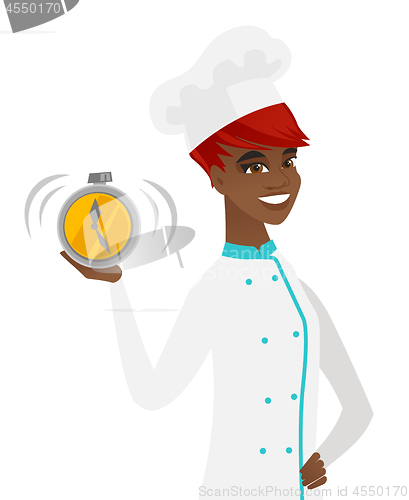 Image of Young african-american chef holding alarm clock.
