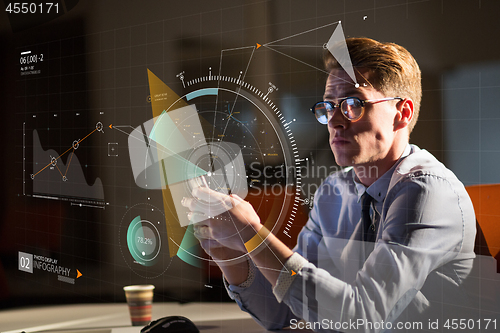 Image of man using mobile phone in dark office