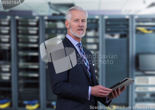 Image of Senior businessman in network server room