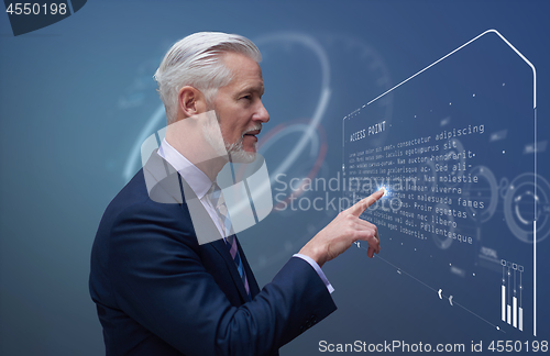 Image of Senior businessman in futuristic room