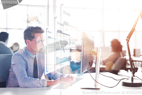 Image of businessman working using a computer in startup office