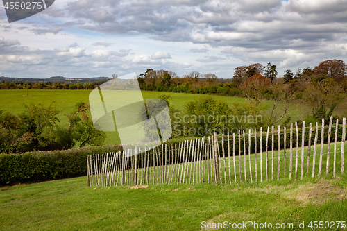 Image of green grass meadow fence in Ireland