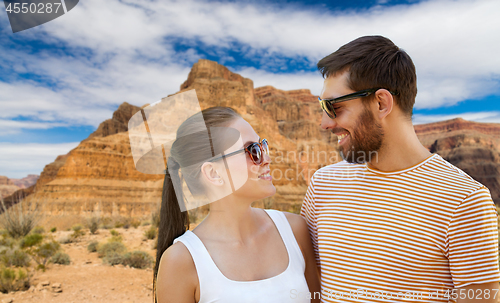 Image of happy couple in sunglasses outdoors in summer