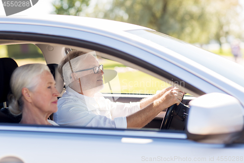 Image of happy senior couple driving in car