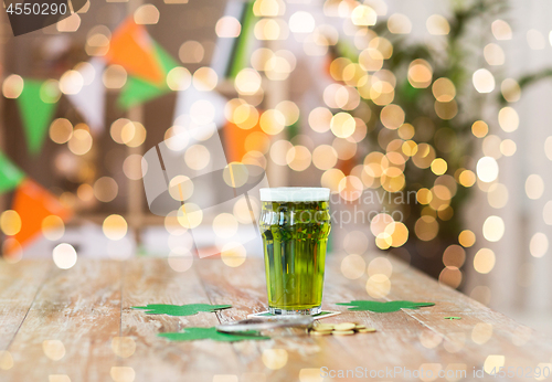 Image of glass of green beer, horseshoe and golden coins