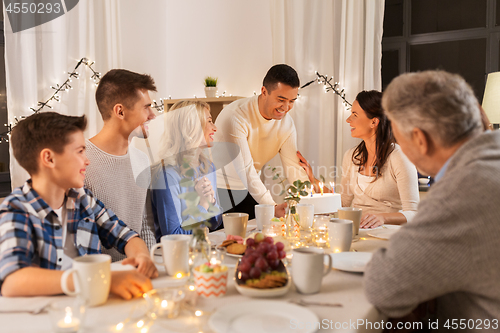 Image of happy family having birthday party at home