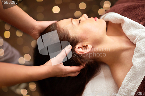 Image of woman having head massage at spa