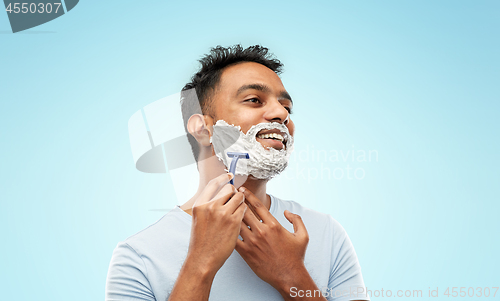 Image of indian man shaving beard with razor blade