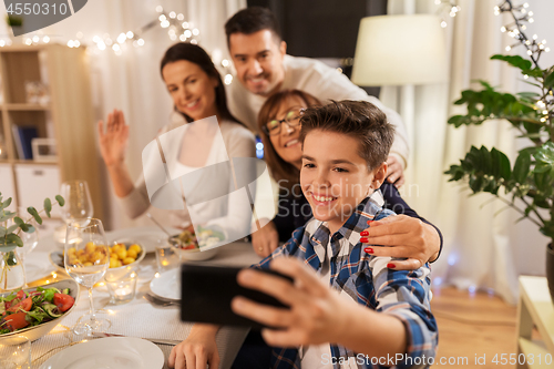 Image of family having dinner party and taking selfie