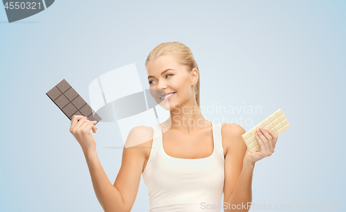 Image of woman choosing between dark and white chocolate