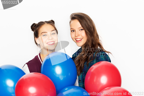 Image of happy teenage girls with helium balloons