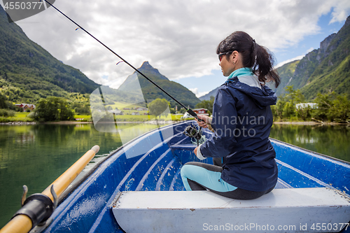 Image of Woman fishing on Fishing rod spinning in Norway.