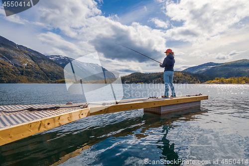 Image of Woman fishing on Fishing rod spinning in Norway.