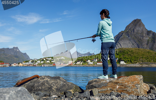 Image of Woman fishing on Fishing rod spinning in Norway.