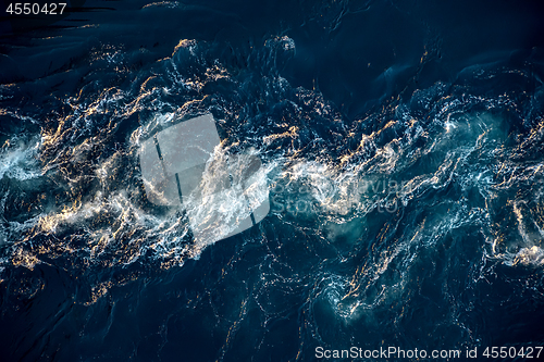 Image of Waves of water of the river and the sea meet each other during h