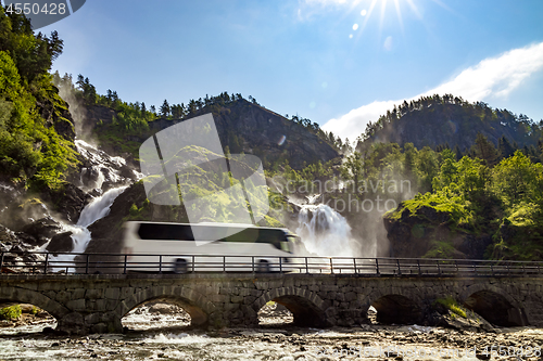 Image of Tourist bus traveling on the road Latefossen Waterfall Odda Norw