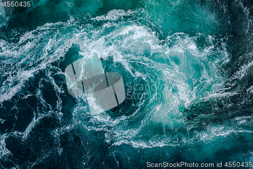 Image of Waves of water of the river and the sea meet each other during h