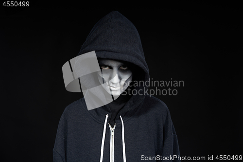 Image of Boy with Halloween zombie makeup with hood on l