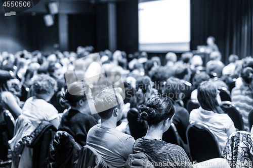 Image of Speaker giving presentation on scientific business conference.