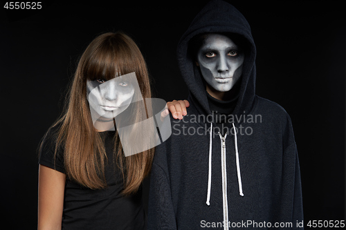 Image of Boy with Halloween zombie makeup with hood on l