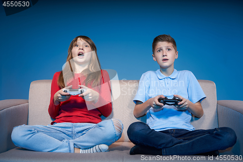 Image of Computer game competition. Gaming concept. Excited girl playing 