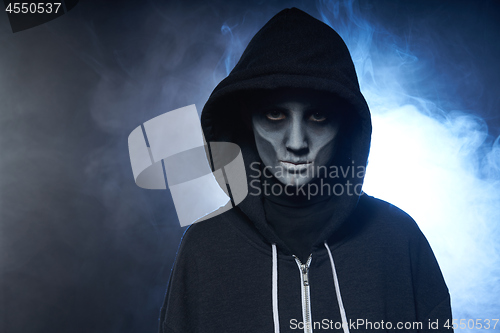 Image of Boy with Halloween zombie makeup with hood on