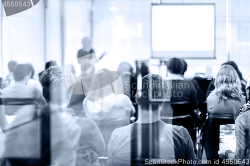 Image of Audience in the lecture hall. Speaker Giving a Talk at Business Meeting.