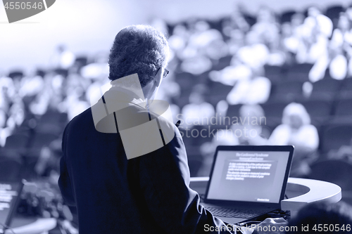 Image of Speaker Giving Presentation at Business Conference at Lecture Hall.