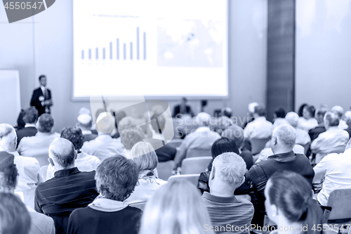 Image of Business speaker giving a talk in conference hall.