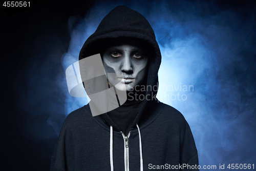 Image of Boy with Halloween zombie makeup with hood on