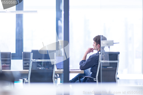 Image of businessman working using a laptop in startup office