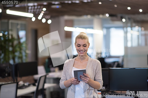 Image of Business Woman Using Digital Tablet in front of startup Office