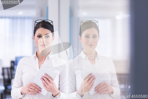 Image of Business Woman Using Digital Tablet in front of startup Office