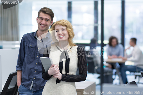 Image of Business People Working With Tablet in startup office