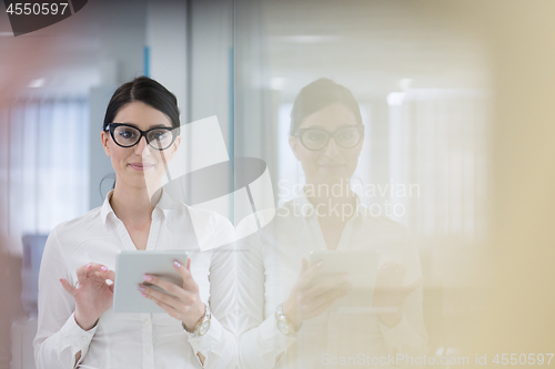 Image of Business Woman Using Digital Tablet in front of startup Office