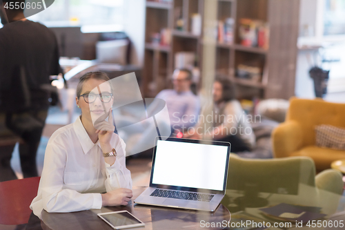 Image of businesswoman using a laptop in startup office