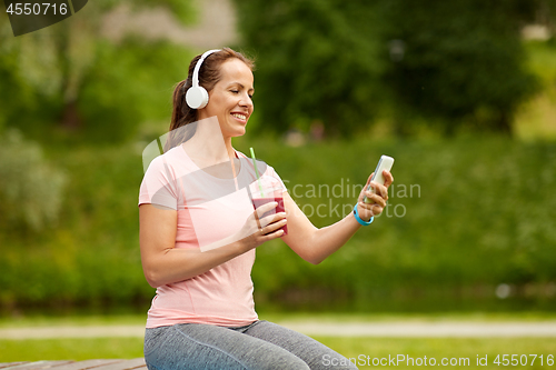 Image of woman with smartphone and shake listening to music