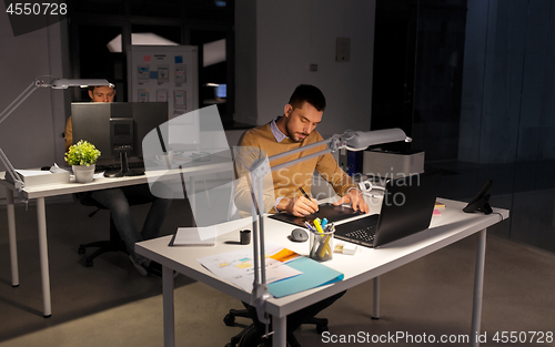 Image of man or designer with computer and tablet at office