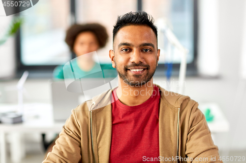 Image of smiling indian man at office