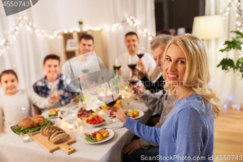 Image of happy family having dinner party at home