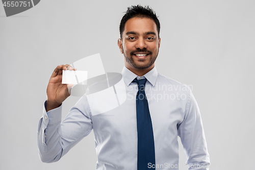 Image of indian businessman with business card over grey