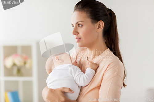 Image of mother holding sleeping baby