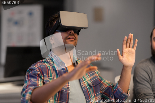 Image of creative man in virtual reality headset at office