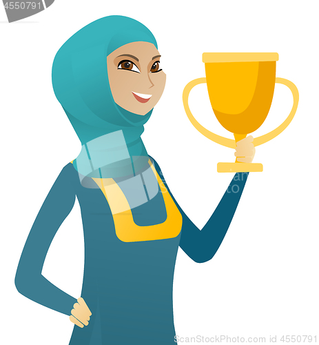 Image of Young muslim business woman holding a trophy.