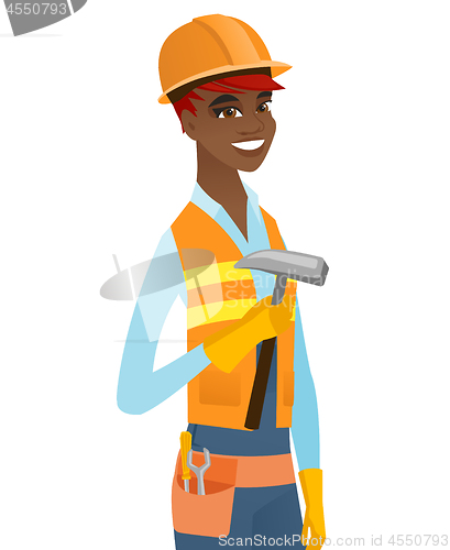 Image of Young african-american carpenter holding a hammer.