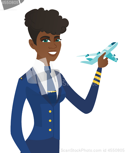 Image of Young african stewardess with model of airplane.