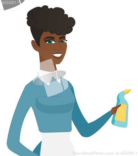 Image of Young african cleaner in uniform holding detergent